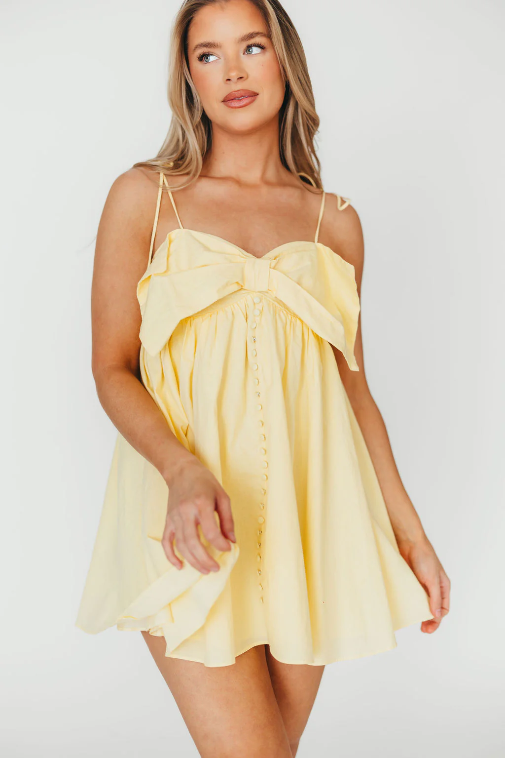 Irelyn Babydoll Mini Dress with Bow Accent in Yellow - Fashionser